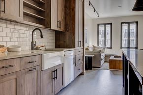 Lehi apartment for rent - A kitchen with wooden cabinets and a white sink.