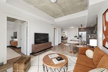 Washington apartment for rent - A living room with a brown couch and a wooden coffee table.