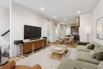Sterling apartment for rent - A living room with a green couch and a wooden coffee table.