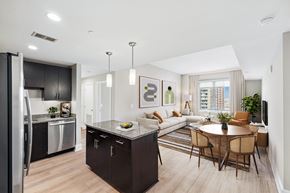 Reston apartment for rent - A modern kitchen with a dining table and chairs.