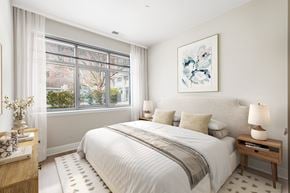 Reston apartment for rent - A bedroom with a large bed and a painting on the wall.