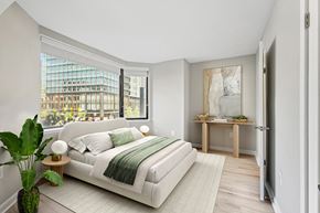 Arlington apartment for rent - a bedroom with a white bed and a large window