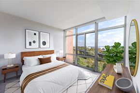 Arlington apartment for rent - a bedroom with floor to ceiling windows looking out on the metro train