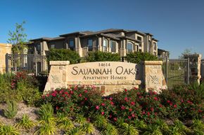 San Antonio apartment for rent - A sign for Savannah Oaks Apartment Homes is in front of a building.