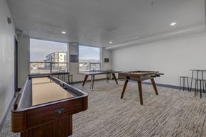 Heber apartment for rent - A game room with a pool table and space for everyone to hang out in a community room with a view of the community and natural outdoor spaces