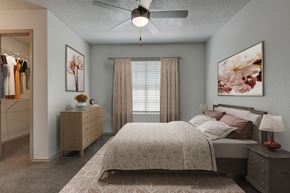 San Antonio apartment for rent - A bedroom with a large bed and a ceiling fan.