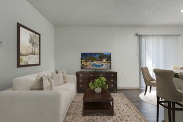 San Antonio apartment for rent - A living room with a white couch, a wooden coffee table, and a painting on the wall.