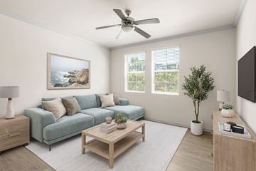 La Mesa apartment for rent - A living room with a blue couch, a wooden coffee table, and a painting on the wall.