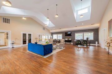 Chapel Hill apartment for rent - A spacious living room with a blue table in the center.