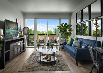 Denver apartment for rent - A living room with a blue couch and a coffee table.