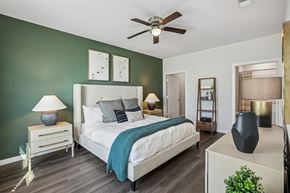 Charlottesville apartment for rent - A bedroom with a bed, nightstands, and a ceiling fan.