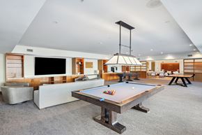 Richmond apartment for rent - A pool table in the middle of a room with a TV and a couch.