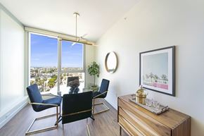 Long Beach apartment for rent - a dining room with a table and chairs and a large window with a view of the city