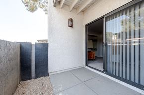 Phoenix apartment for rent - A patio area with a sliding glass door leading to a dining area.