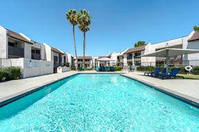 Phoenix apartment for rent - A long rectangular swimming pool in front of apartment buildings.