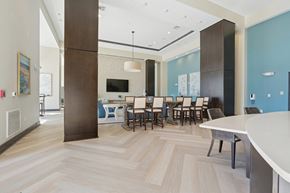 Charleston apartment for rent - A modern dining room with a white table and chairs.