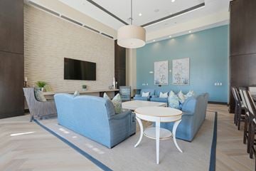 Charleston apartment for rent - A modern living room with a blue sofa and a white coffee table.