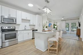 Charleston apartment for rent - A modern kitchen with white cabinets and stainless steel appliances.