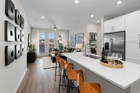 Charlotte apartment for rent - A modern kitchen with a dining table and chairs.