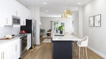 Charlotte apartment for rent - A modern kitchen with a dark blue island and white cabinets.