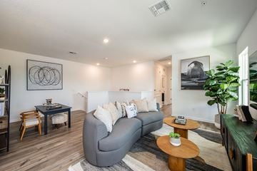 Sanford apartment for rent - A living room with a grey couch and a wooden coffee table.