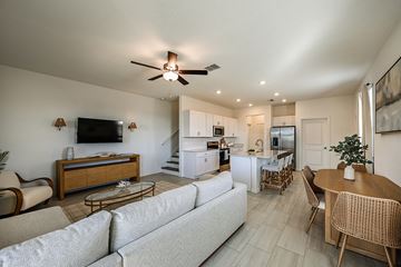 Wimauma apartment for rent - A living room with a grey couch and a wooden coffee table.