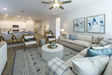 Cypress apartment for rent - A living room with a white couch and a grey rug.
