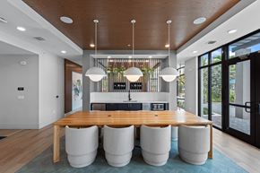 Miramar apartment for rent - A modern dining room with a wooden table and white chairs.