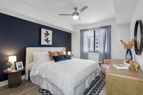 Miramar apartment for rent - A bedroom with a large bed and a ceiling fan.