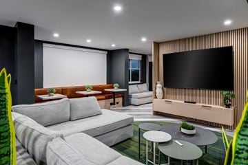 Fort Lauderdale apartment for rent - A modern living room with a grey sofa and a black television.
