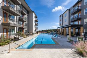 Austin apartment for rent - an apartment building with a swimming pool in the middle of it