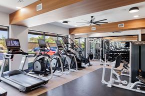 Austin apartment for rent - a gym with treadmills and other exercise equipment on the floor