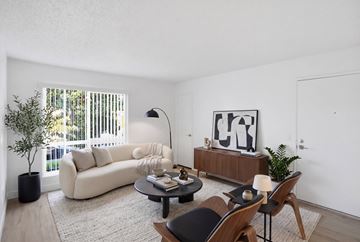 Chula Vista apartment for rent - A living room with a white couch, a coffee table, and a painting on the wall.