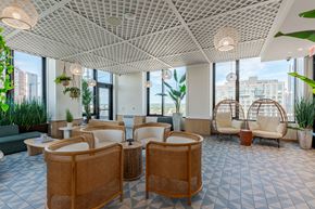 New Rochelle apartment for rent - A spacious waiting area with wicker chairs and tables.