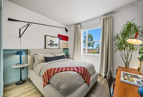 San Diego apartment for rent - A bedroom with a bed, a desk, and a window.