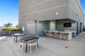 Los Angeles apartment for rent - the patio of the building has tables and chairs and a bar