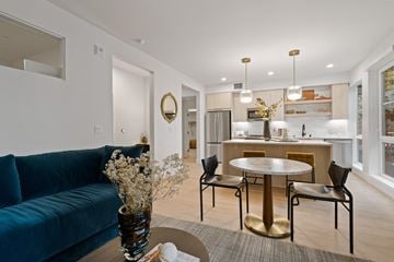 Long Beach apartment for rent - a living room and dining area with a blue couch and a round table