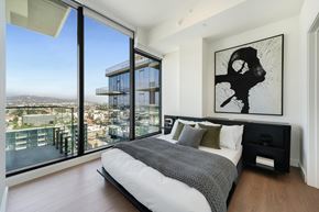 Los Angeles apartment for rent - a bedroom with a bed and a view of the city