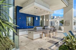 Los Angeles apartment for rent - A modern outdoor kitchen area with a dining table and chairs.