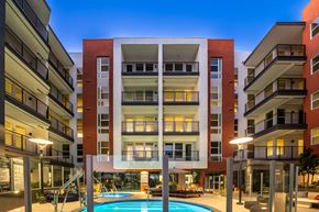 San Diego apartment for rent - A modern apartment building with a pool in the courtyard.