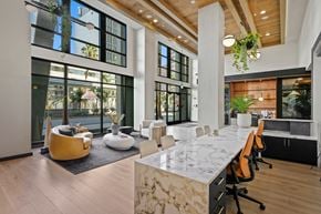 Long Beach apartment for rent - a large conference room with large windows and a marble table and chairs