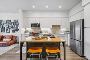 San Diego apartment for rent - A modern kitchen with a wooden table and orange chairs.