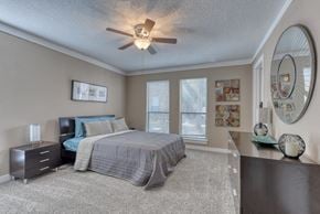 San Antonio apartment for rent - a bedroom with a bed and a ceiling fan