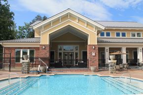 Woodbridge apartment for rent - a swimming pool in front of a building with a resort style pool