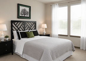 Woodbridge apartment for rent - Spacious apartment bedroom featuring a large bed, bedside lamps, wall art, and ample natural light at Stone Pointe.