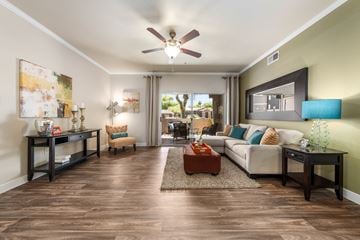 Chandler apartment for rent - A living room with a white couch, a brown coffee table, and a painting on the wall.