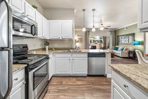 Chandler apartment for rent - A kitchen with white cabinets and a granite countertop. at Stonebridge Ranch Apartments, Arizona, 85225