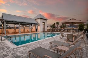 Panama City apartment for rent - a resort style pool with lounge chairs and umbrellas