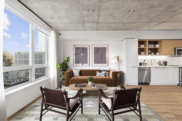 Seattle apartment for rent - A modern living room with a brown couch and a coffee table.