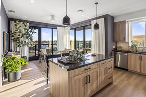 San Diego apartment for rent - A modern kitchen with wooden cabinets and a large island.